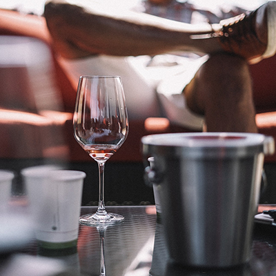 man sitting in front of table with wine glass