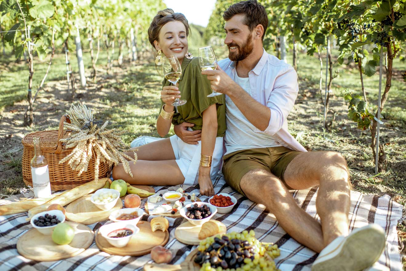 Couple enjoying a picnic among the vines